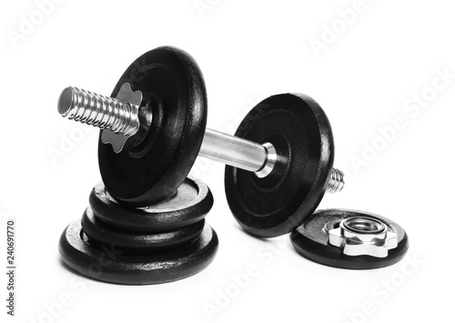 Professional dumbbell and weight plates on white background. Sporting equipment