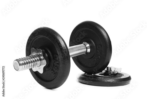 Professional dumbbell and weight plate on white background. Sporting equipment