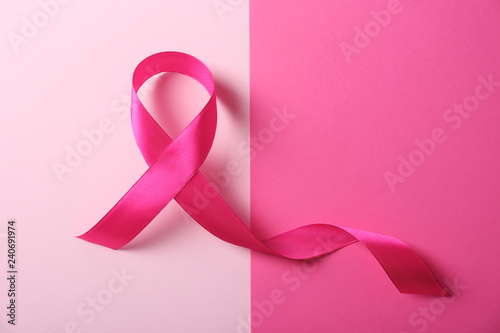 Pink ribbon and space for text on color background. Breast cancer awareness concept