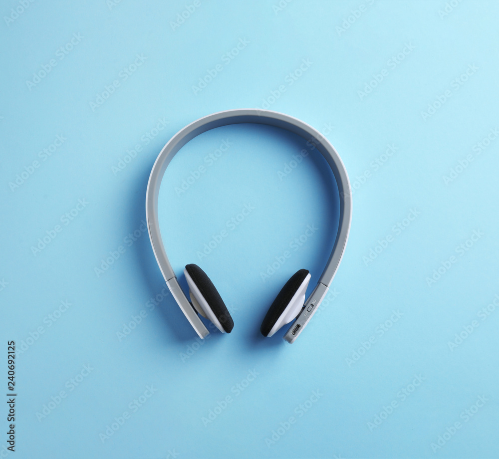 Wireless headphones on color background, top view Wireless headphones on color background, top view
