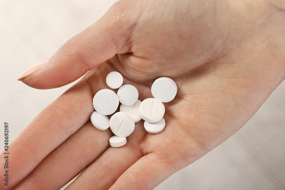 Woman holding many pills in hand, closeup view Woman holding many pills in hand, closeup view