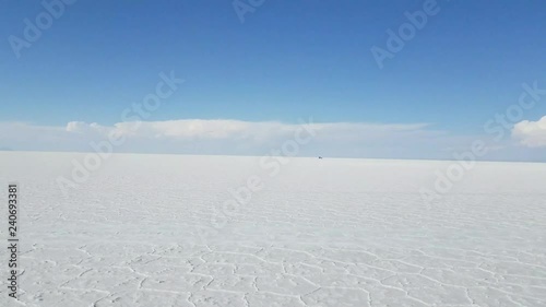 Off-road vehicle driving on Salar de Uyuni, Bolivia. South America