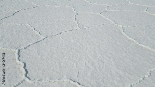 Walking through the Uyuni Salar in Bolivia. Close up on the hexagon salt flats. Uyuni, Potosi Bolivia.