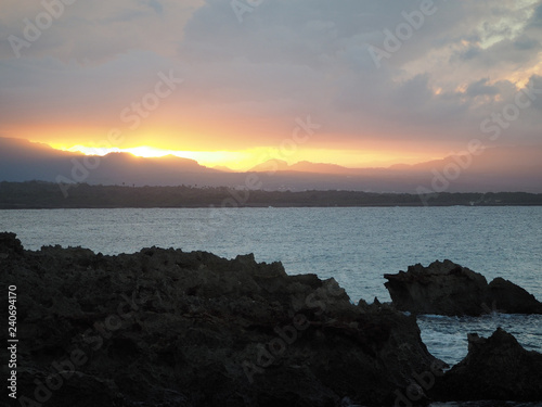 The mountains and the ocean are a beautiful sunset.