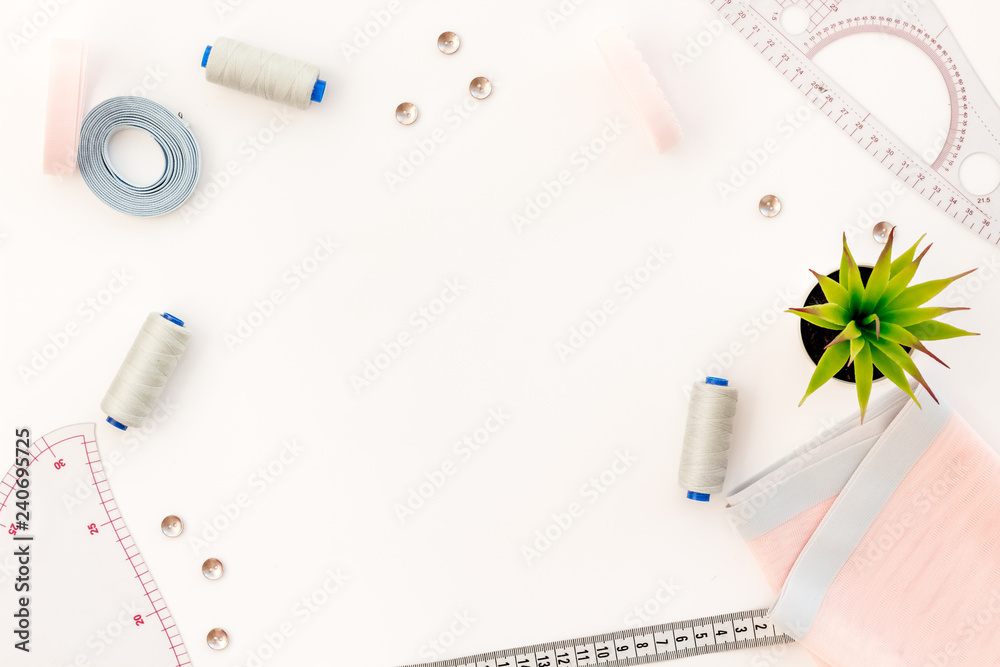 Tailor work place with thread, fabric. Sewing as hobby. White background top view space for text Tailor work place with thread, fabric. Sewing as hobby. White background top view space for text