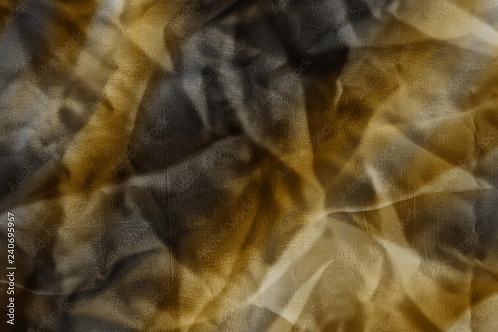 Luxury gold textile background. Silk cloth texture. Fabric pattern.