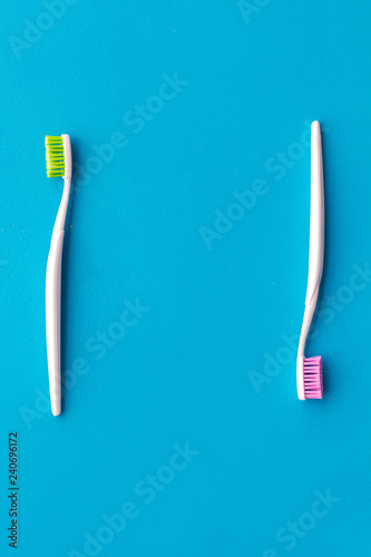 Tooth care with toothbrush. Set of cleaning products for teeth on blue background top view mockup