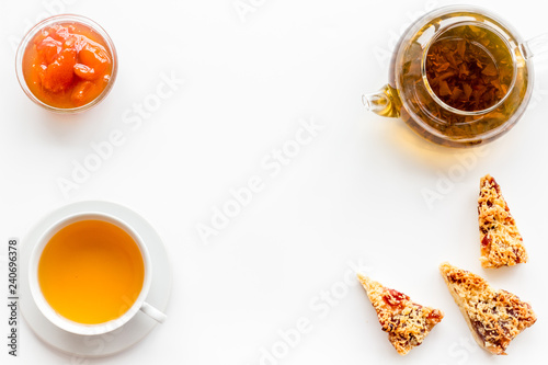 Tea with homemade cookies. Fresh cookies, cup of tea, teapot on white background top view space for text