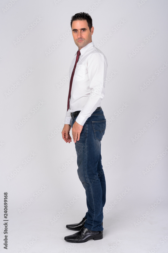 Full body shot profile view of handsome businessman against white background Full body shot profile view of handsome businessman against white background