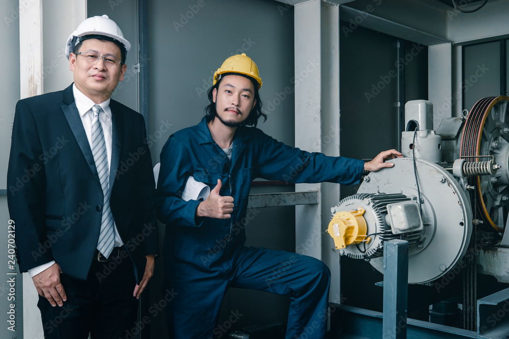 Asian engineers standing and smile to camera..