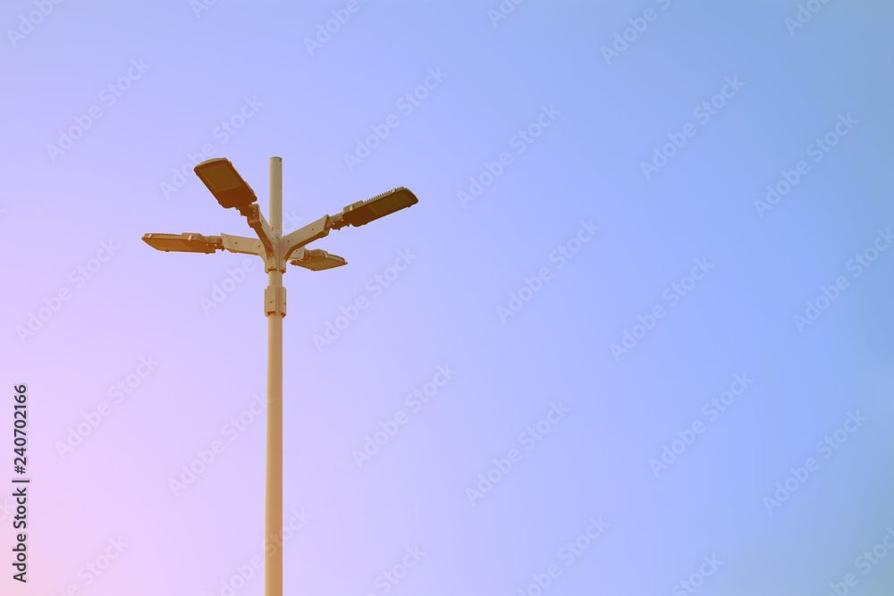 Electrical light pole in cross shape with background of clear sky