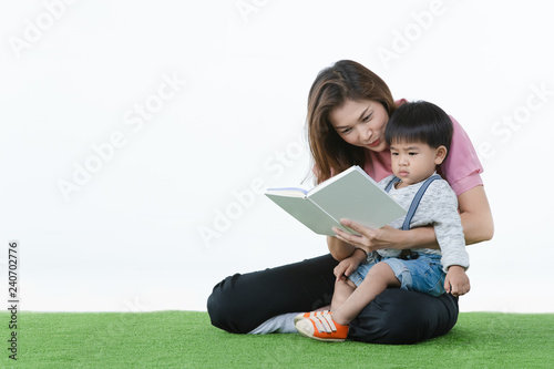 Asian kid reading with mother