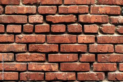 Old brick wall with red bricks close up