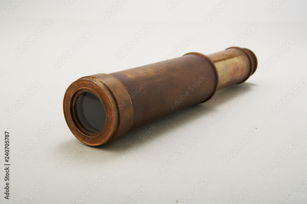 Antique telescope on white background