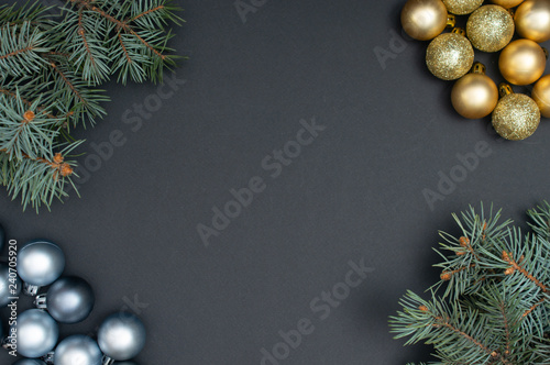 Multiple Christmas silver and gold baubles creative decoration pattern with pine tree branches on the black background