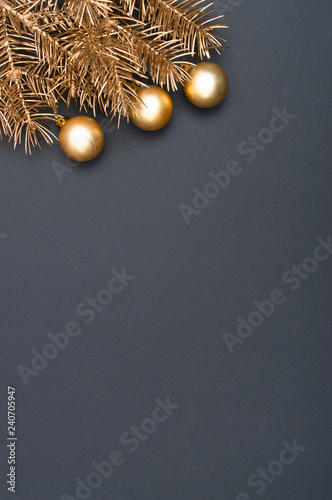 Creative decoration pattern with golden Christmas tree branches and baubles. Concept