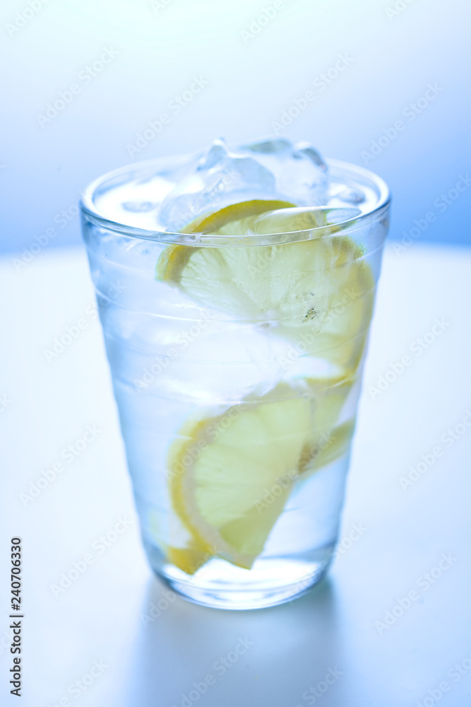 Glass of ice water with lemon 