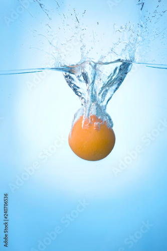 Tropical fruits fall under water with a big splash