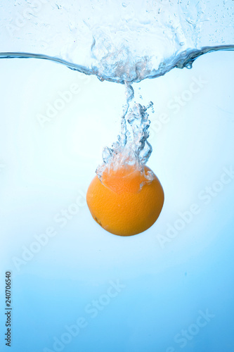 Tropical fruits fall under water with a big splash
