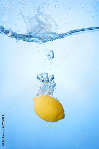 Tropical fruits fall under water with a big splash