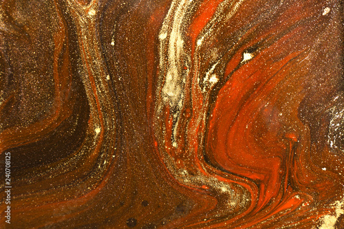 Gold marbling texture design. Red and golden marble pattern. Fluid art.