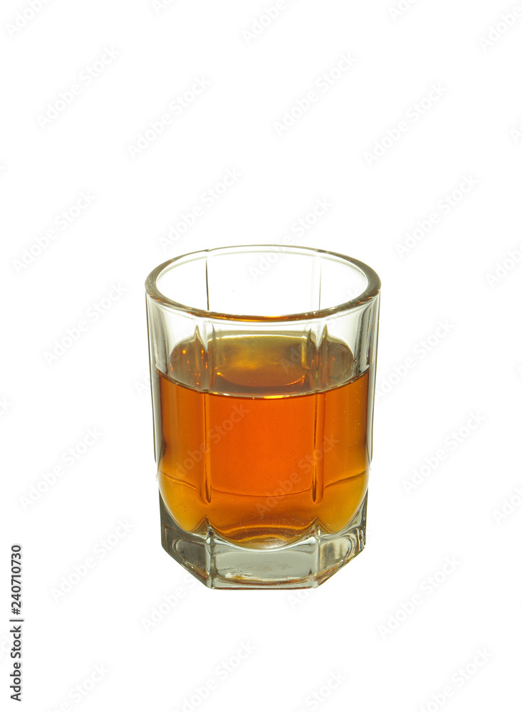 A glass of brandy on a white background. Isolated on white. A glass of brandy on a white background. Isolated on white.