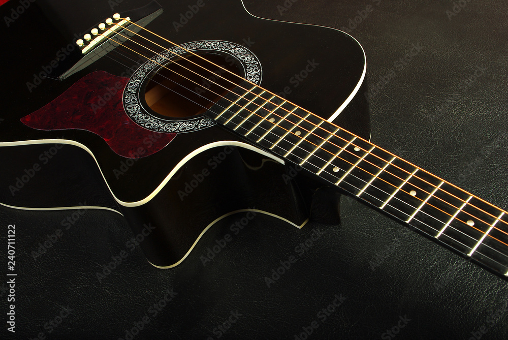 Fototapeta premium Acoustic black guitar. Close-up