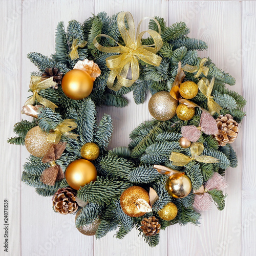Advent  Christmas wreath with gold decorations, handmade on a wooden background. Year's interior decoration