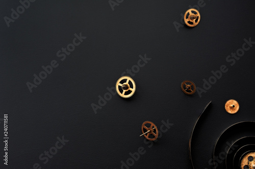 Gears on a black background.Broken mechanism.Spring from wall clock