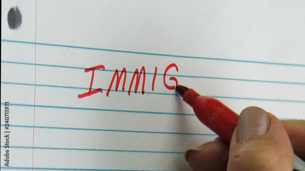 Hand writing immigration on a notebook