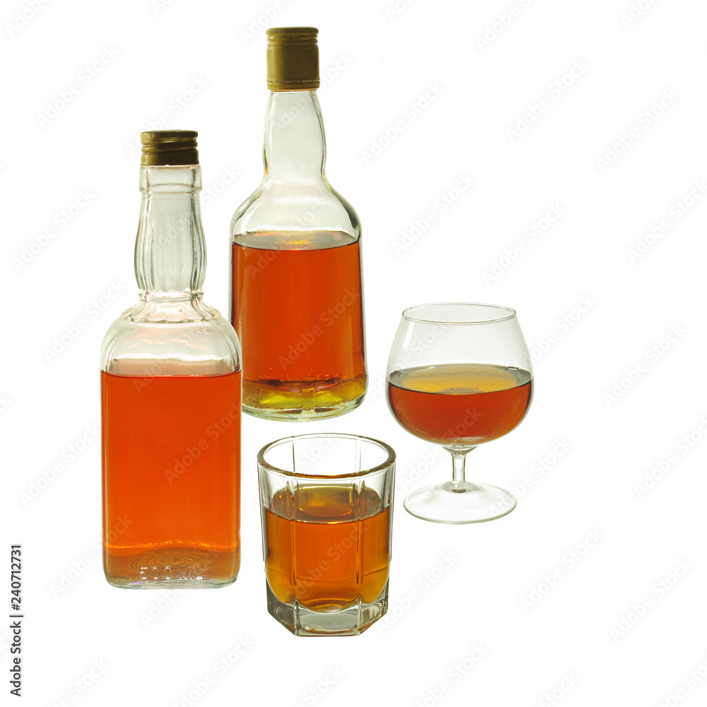 Whiskey and gin in glasses and bottles on a white background. Isolated on white