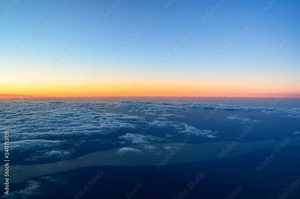 above the clouds, a beautiful dawn at an altitude of 10,000 meters, the Volga River