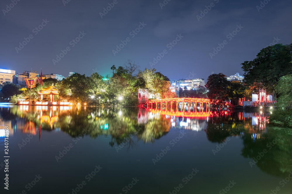 View of building huc red bridge with shrine in Hoan Kiem lake