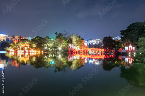 View of building huc red bridge with shrine in Hoan Kiem lake