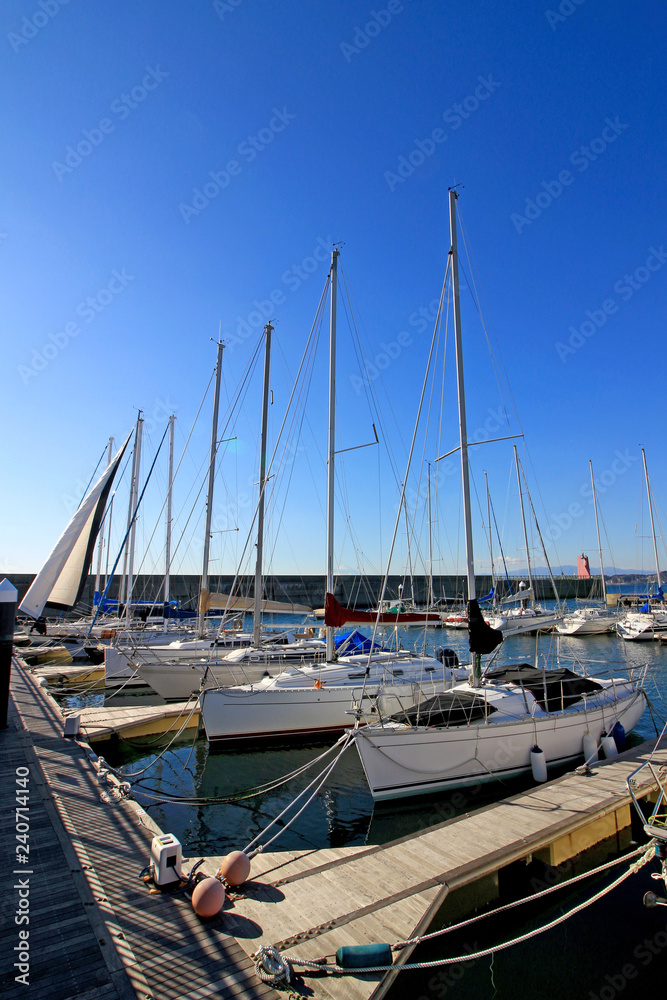 Fototapeta premium Scenery of yacht harbor facing calm sea of summer
