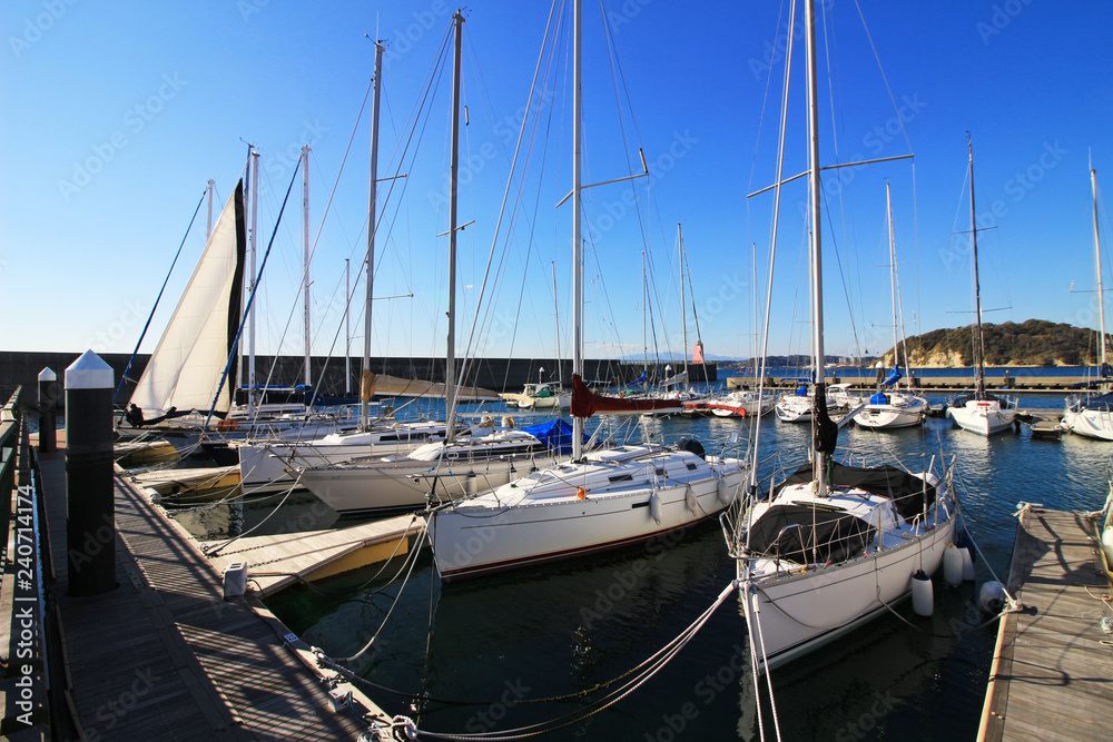 Fototapeta premium Scenery of yacht harbor facing calm sea of summer