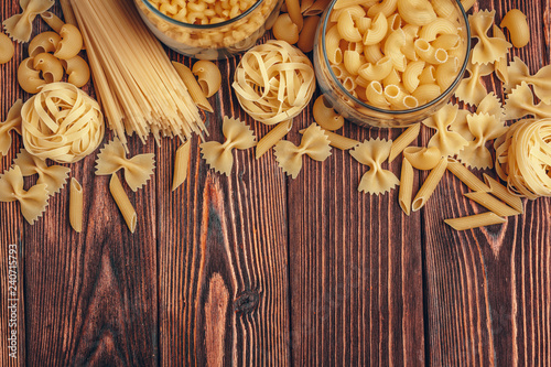 Various types of Italian pasta rustic background