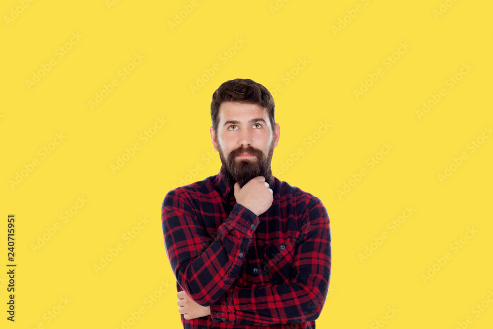 Hipster man with big beard on a yellow background