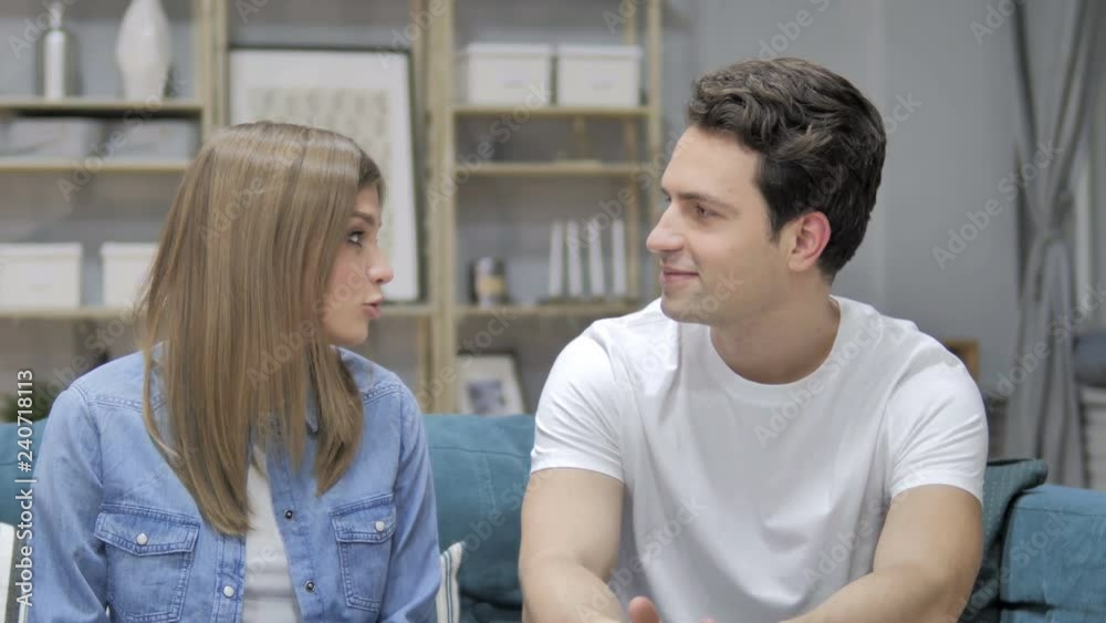 Talking Happy Couple Relaxing on Couch and Discussing Future Talking Happy Couple Relaxing on Couch and Discussing Future