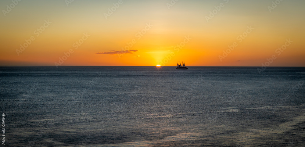 Sunset backgound with sailing cruise ship.