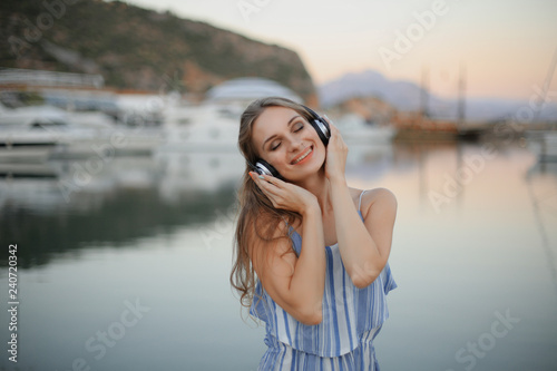 portrait of young woman listen to music on the beach