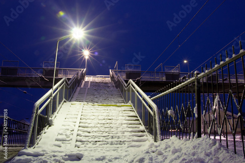 Fototapeta Naklejka Na Ścianę i Meble -  empty pathway on the overpass bridge under the sky train railway track at winter morning