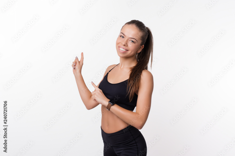 Portrait of happy sport woman pointing away Portrait of happy sport woman pointing away
