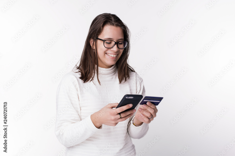 Portrait of a happy woman buying online with a smart phone and holding credit card Portrait of a happy woman buying online with a smart phone and holding credit card