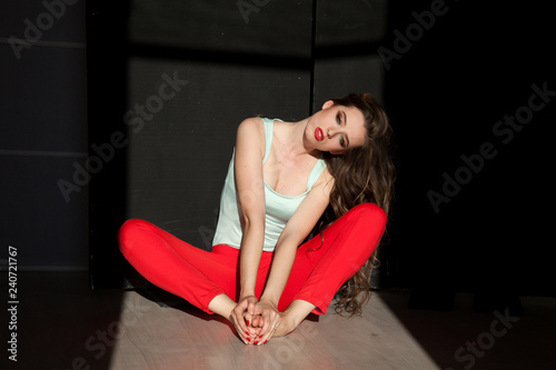 Portrait of beautiful fashionable woman in red pants