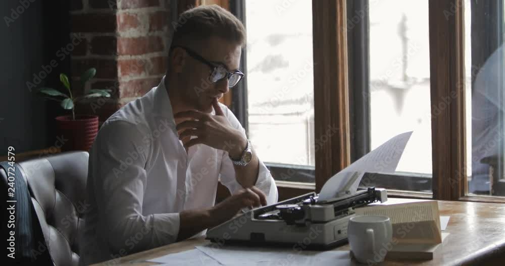 Inspired writer working on new, exciting novel, typing text on vintage typewriter in sweet home on cold winter day Inspired writer working on new, exciting novel, typing text on vintage typewriter in sweet home on cold winter day