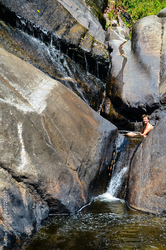 Naklejka premium Cooling down at the waterfall