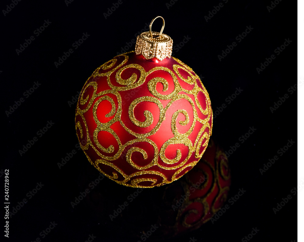 Ball ornament on black surface. Pick decor for christmas tree. Christmas ornament single red ball on black background. Christmas ornament concept. Elegant and luxury christmas decor close up Ball ornament on black surface. Pick decor for christmas tree. Christmas ornament single red ball on black background. Christmas ornament concept. Elegant and luxury christmas decor close up
