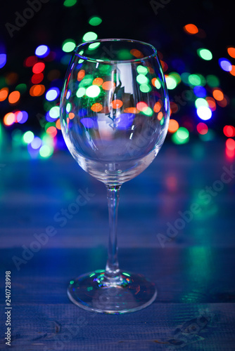 Alcohol cocktail for winter party. Cocktail ideas concept. Easy recipes for winter alcoholic cocktail drinks. Cocktail glass on defocused garland colorful lights. What to drink on christmas party