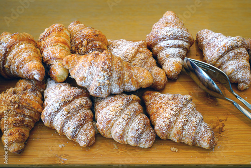 Freshly baked French praline almond croissants photo